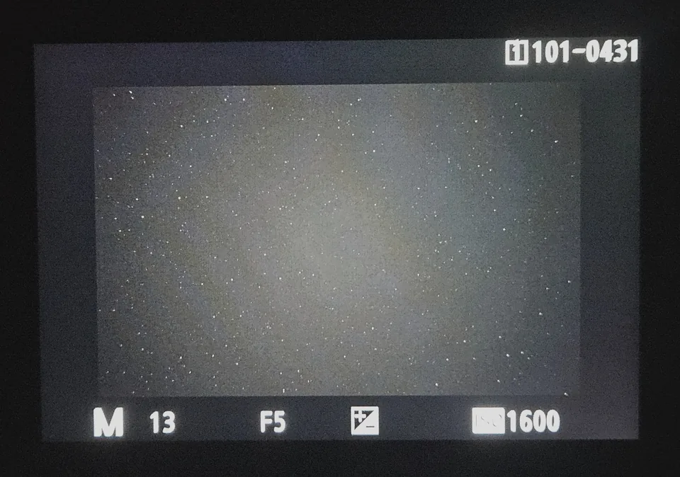 The back of a camera at night, showing a test shot full of stars, 13 seconds at f/5 and ISO 1600, with a large question mark over it.